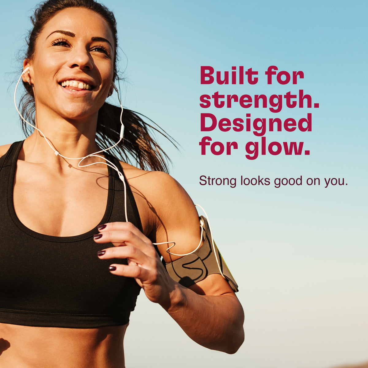 Physically fit and strong woman in athletic wear with text 'Built for strength. Designed for glow.' on a blue background